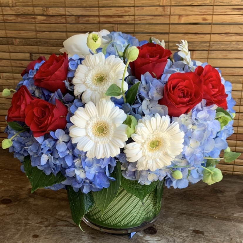 Red rose, white gerbera, and blue hydrangea celebration bouquet