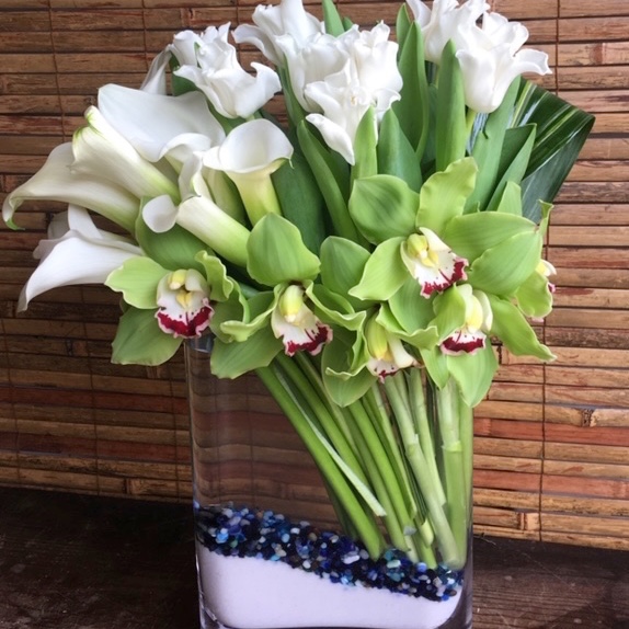 Green cymbidium orchid, calla lily, and white tulip arrangement