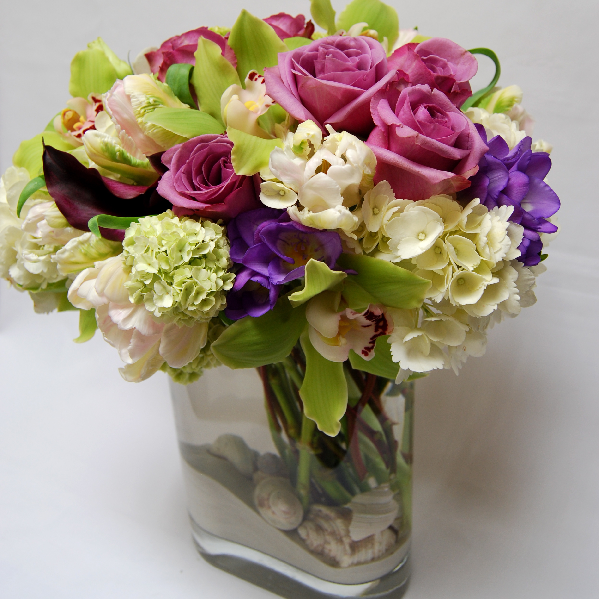 Cymbidium orchid, garden rose, and purple accent bouquet