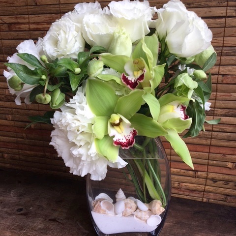 Lush green orchid and white peony vase arrangement