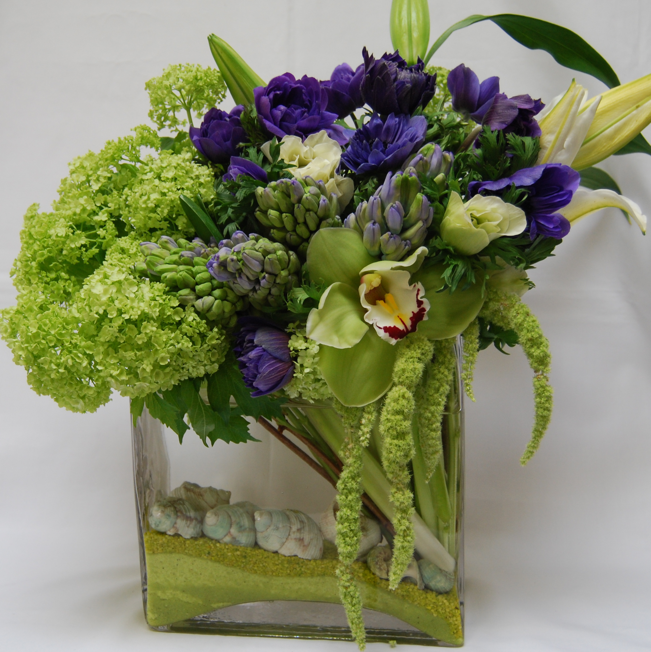 Green hydrangea, artichoke, and purple anemone modern design